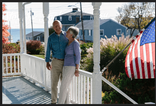 Senior Couple on Porch with American Flag