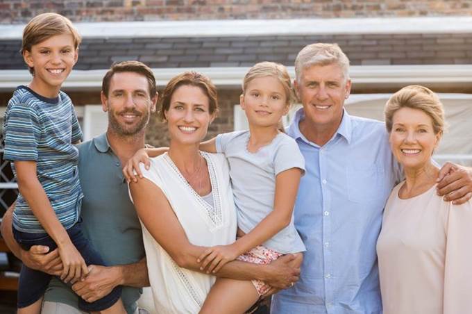 Grandparents with Kids and Grandkids Smiling at Camera