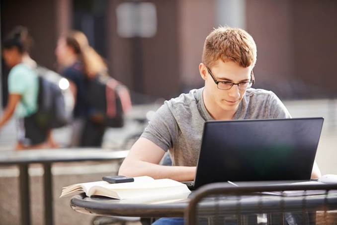 Student Studying on Laptop Outside