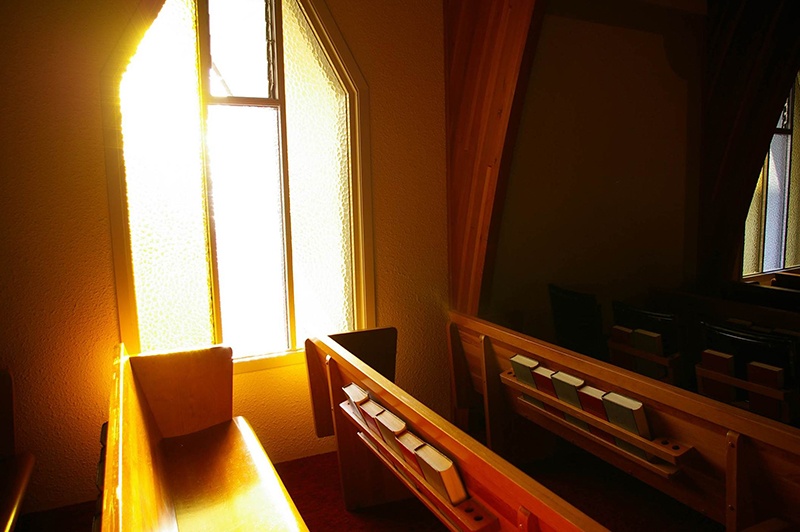 Sun Shining on Pew in Church